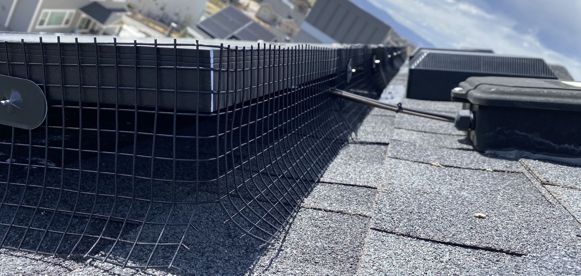 A bird fence is installed on the roof of a house