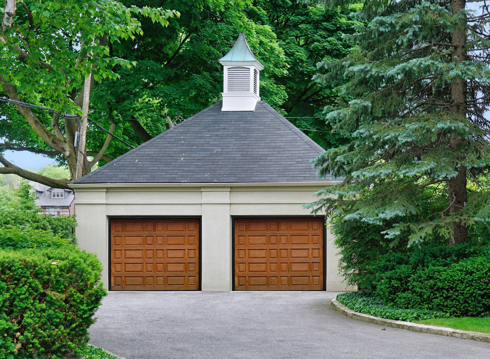 Patio with stone paving, outdoor furniture, and a house with green siding. Sunny day. Patio with stone paving, outdoor furniture, and a house with green siding. Sunny day.