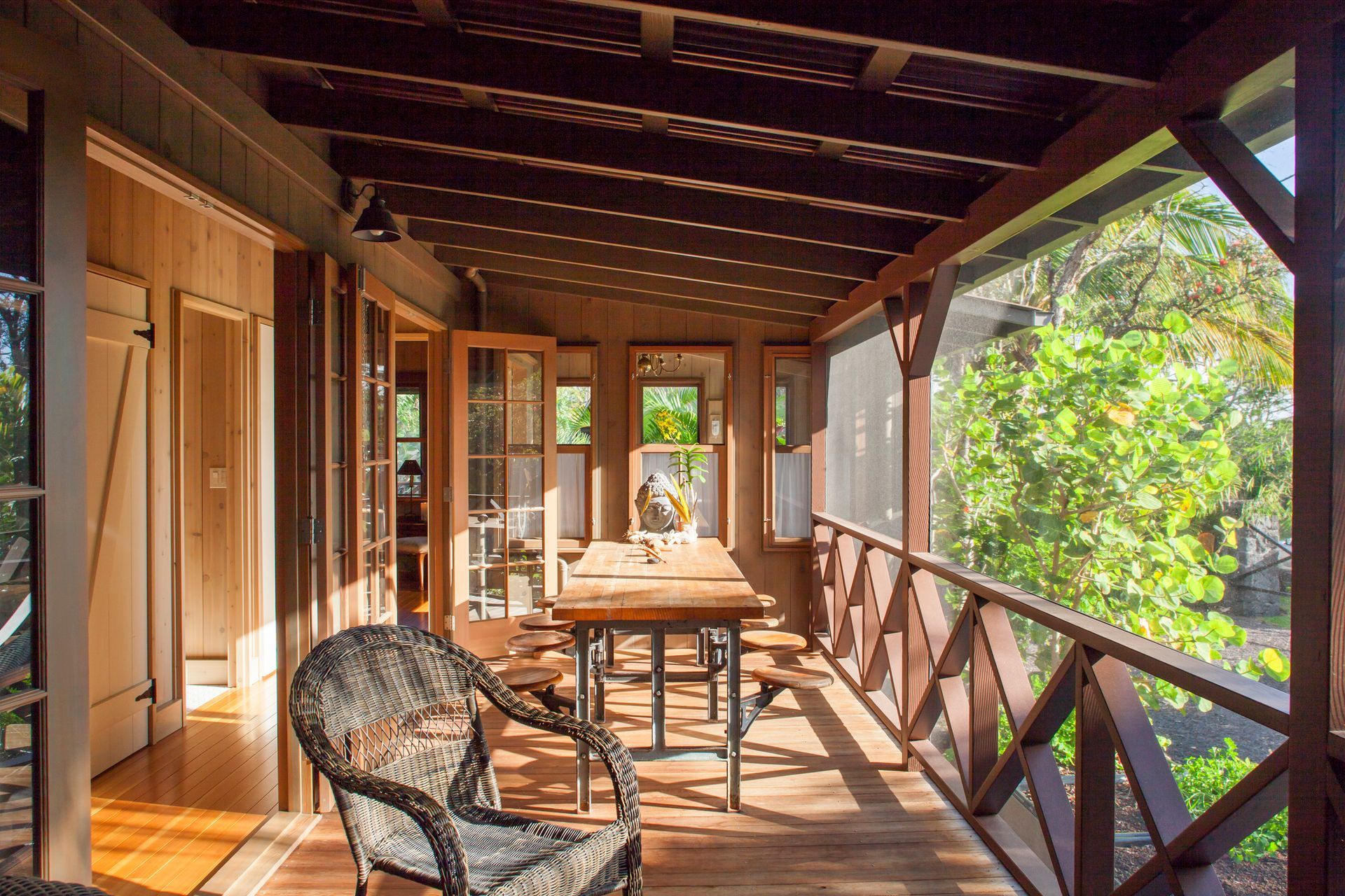 Newly installed wooden deck with tools, near a white railing and grass.