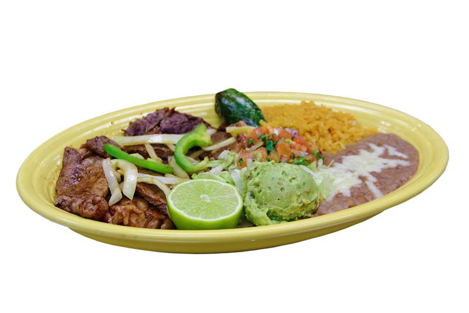 A yellow plate topped with a variety of mexican food.