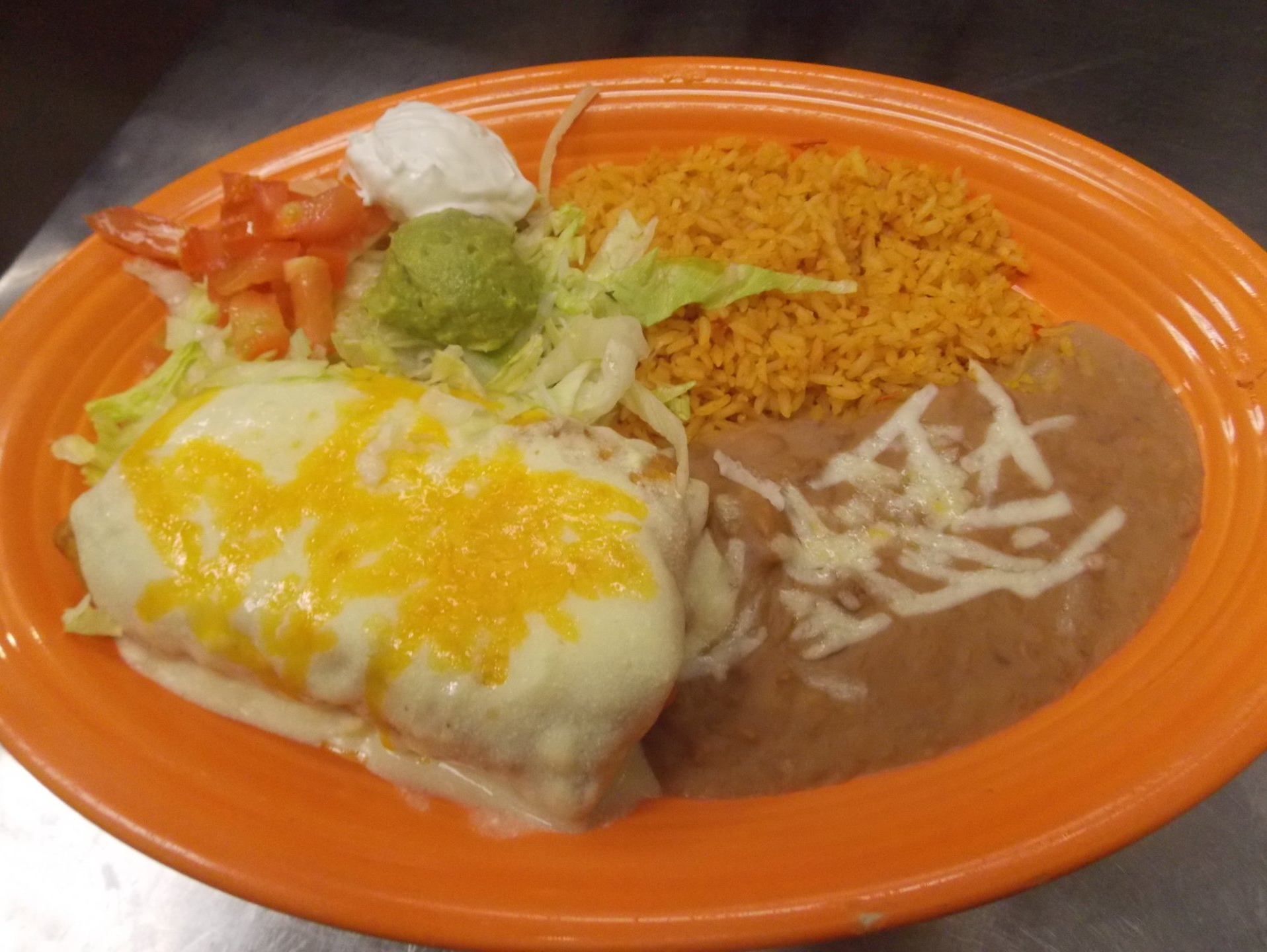 A close up of a plate of food with rice and beans