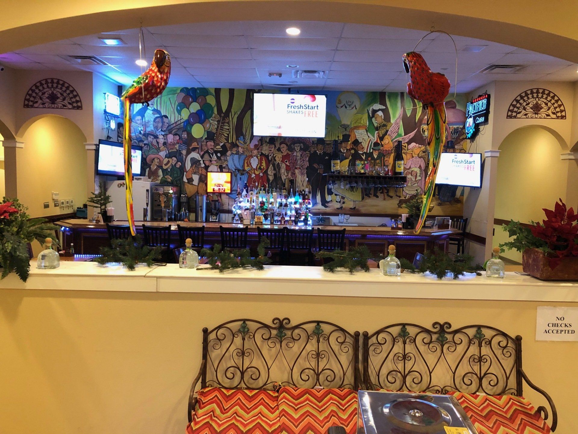 A restaurant with a bar and a couch in front of it.