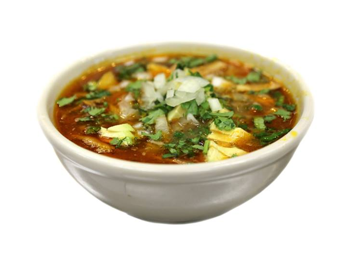 A bowl of soup with onions and cilantro on a white background.