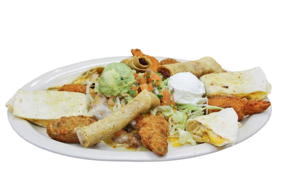 A white plate topped with a variety of mexican food
