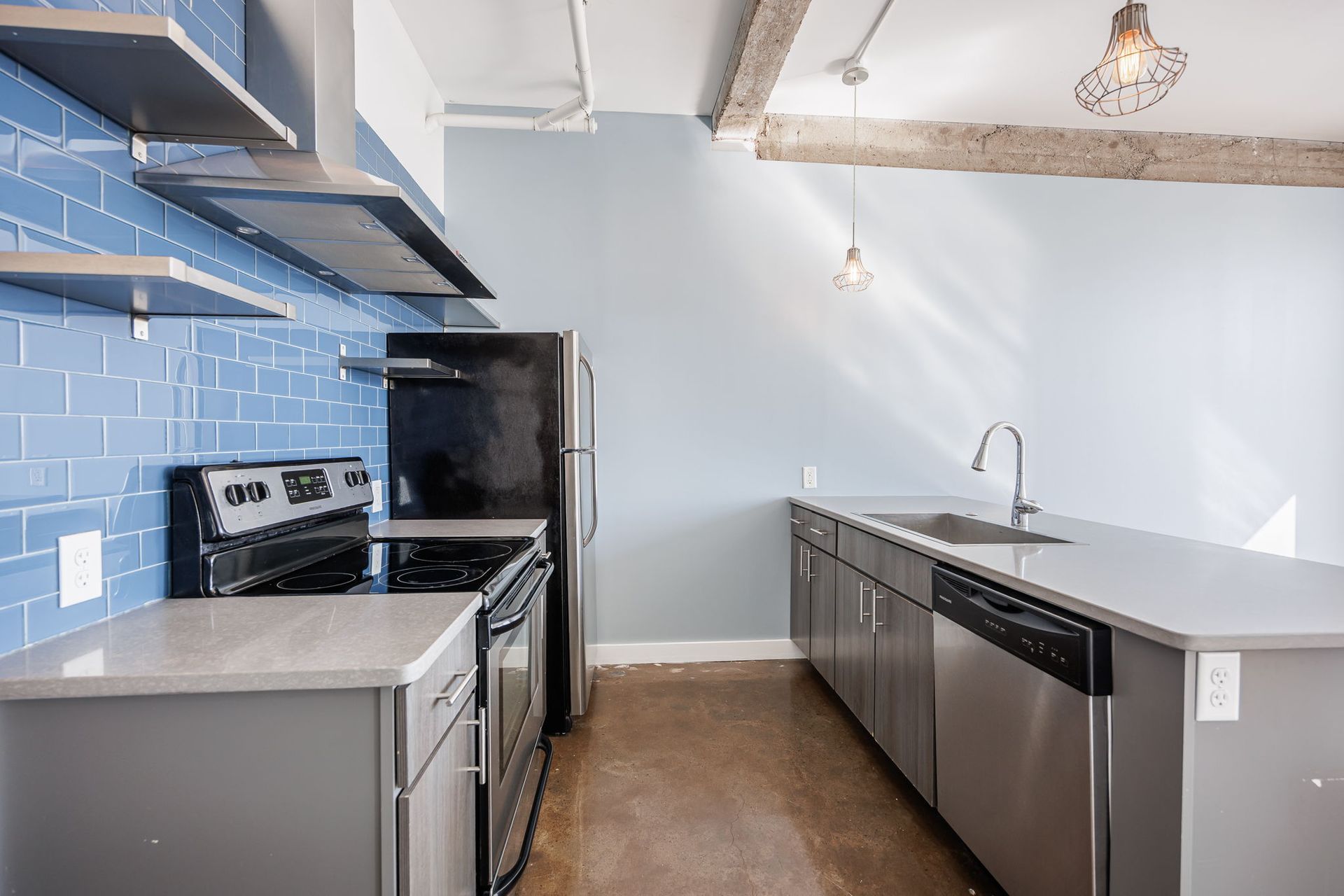Modern kitchen with a blue backsplash and stainless steel appliances
