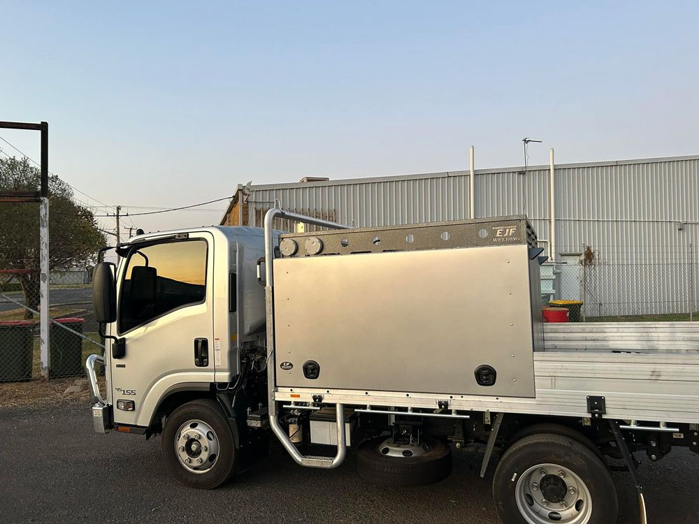 A Silver Truck Is Parked in Front of A Building — EJF Welding in Dubbo, NSW