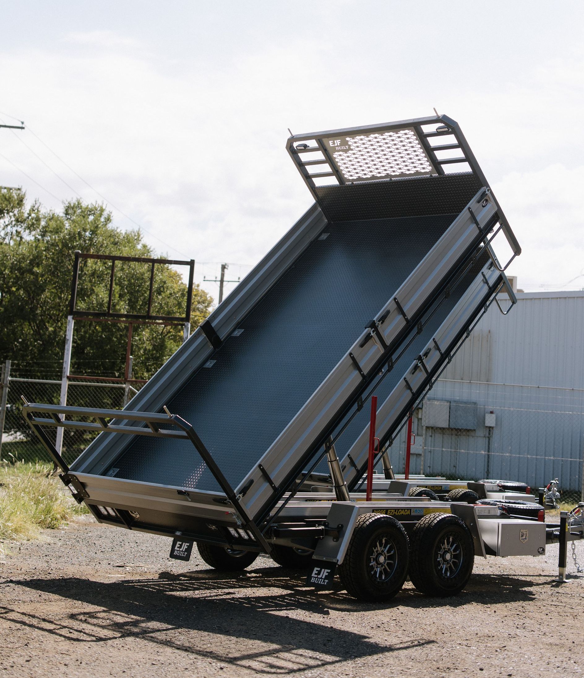 A Silver Utility Dump Trailer With Its Bed Raised — EJF Built in Dubbo, NSW