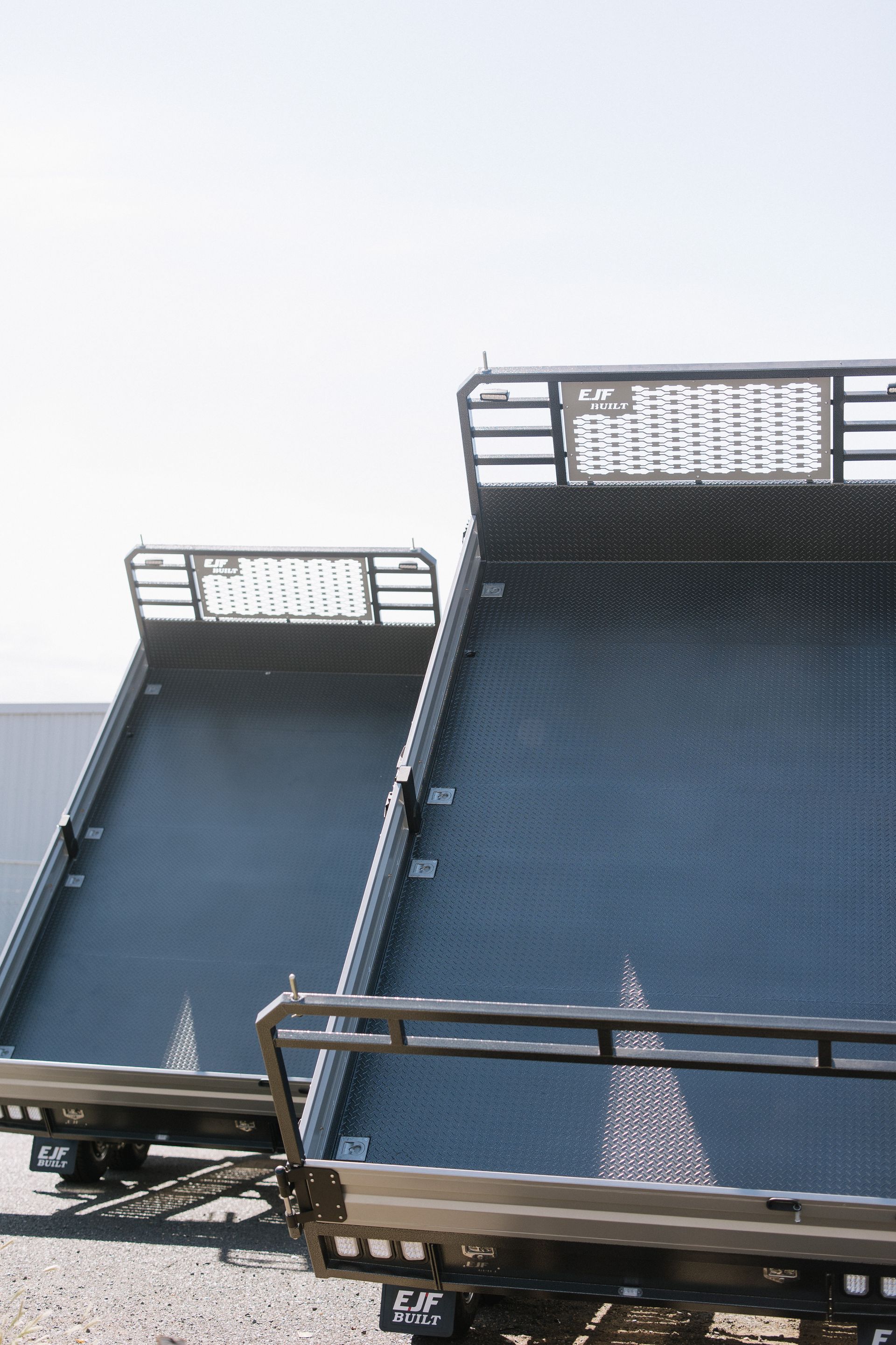 Two Empty, Dark Truck Beds Angled Toward the Sky — EJF Built in Dubbo, NSW