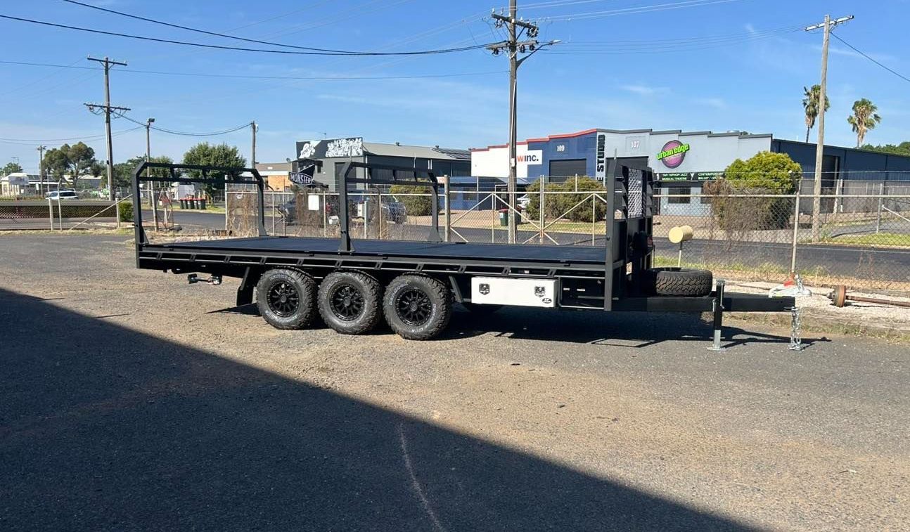 Black Flatbed Trailer with Triple Axles Parked on Asphalt — EJF Built in Dubbo, NSW