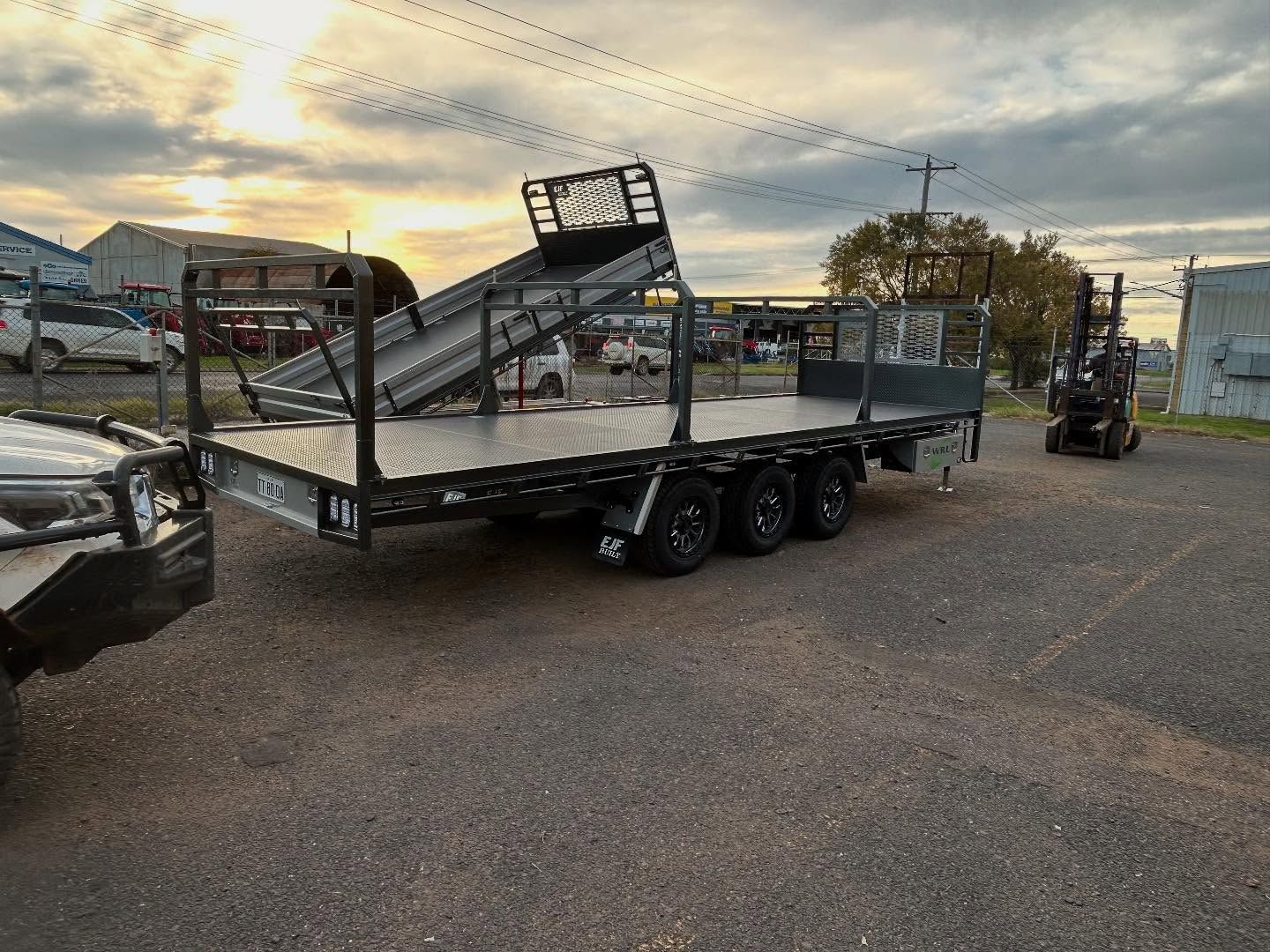 Black Flatbed Trailer With a Raised Tilting Section — EJF Built in Dubbo, NSW