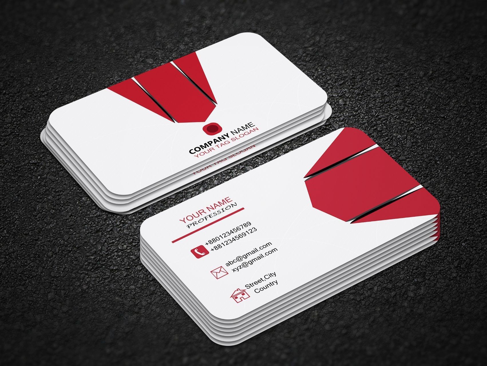 Red and white business cards stacked on a textured black surface.