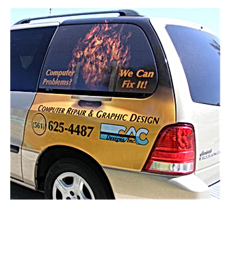 Van with advertisement for computer repair: text, fire graphic, phone number (561) 625-4487.