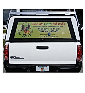 White Toyota Tacoma truck with a window advertisement for 