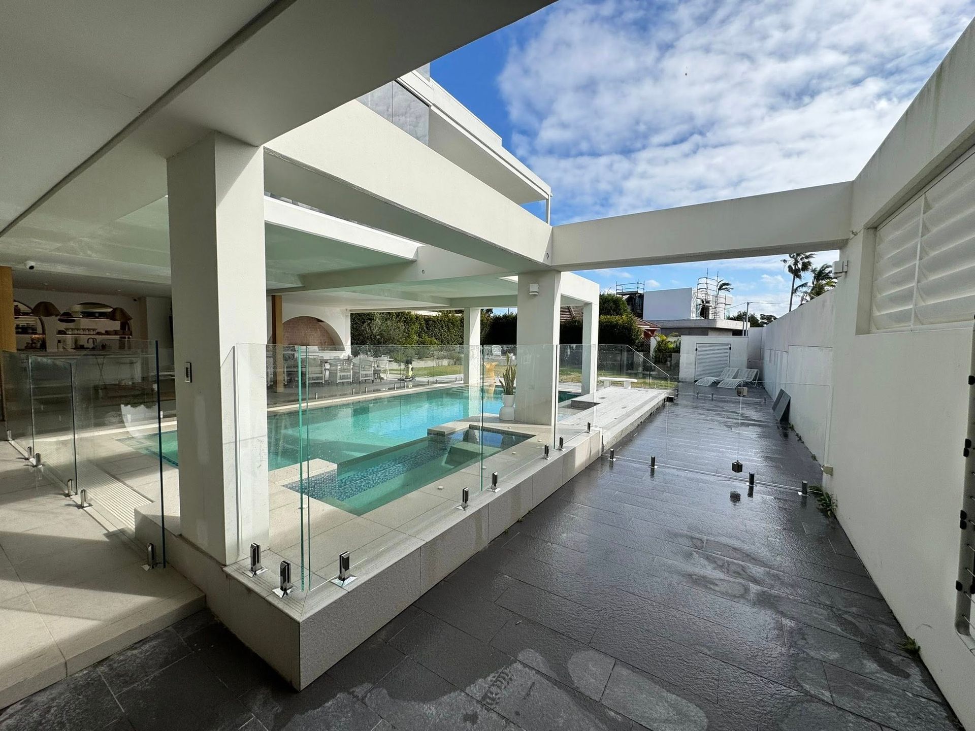 A Modern Home Exterior With a Swimming Pool, Glass Fencing — ClearView Glass Pool Fencing In Roselands, NSW
