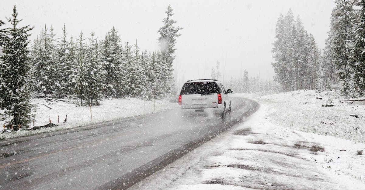 A car is driving down a snowy road. | Curt's Service Inc.