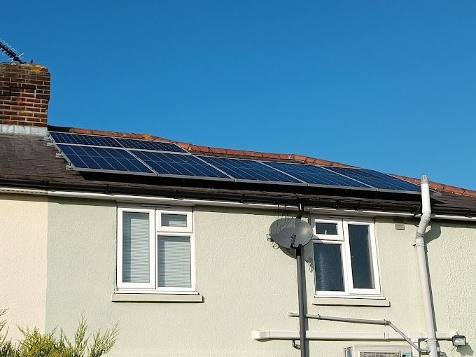 A house with a lot of solar panels on the roof.