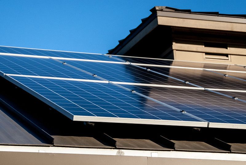 A row of solar panels on the roof of a house