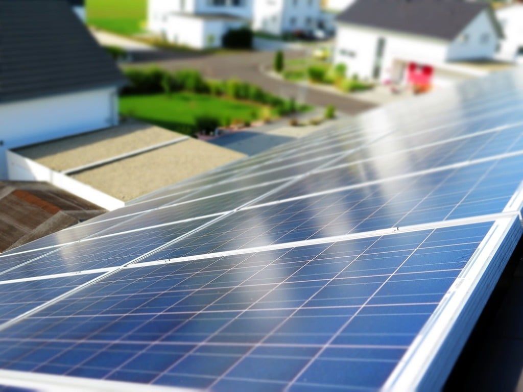 A row of solar panels on the roof of a house