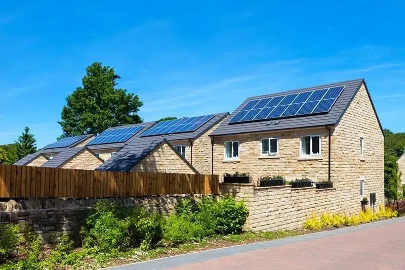 A brick house with solar panels on the roof.