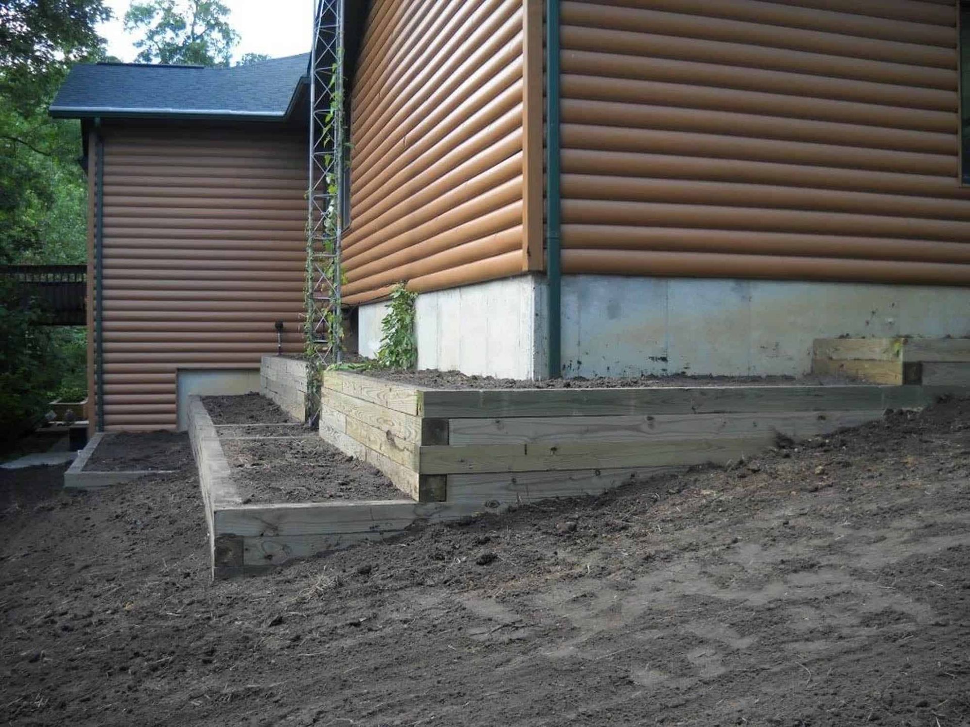 A house with a wooden siding and a concrete foundation