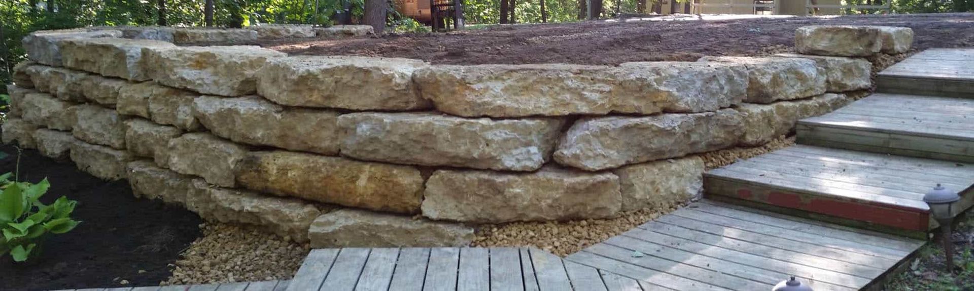A stone wall with stairs leading up to it