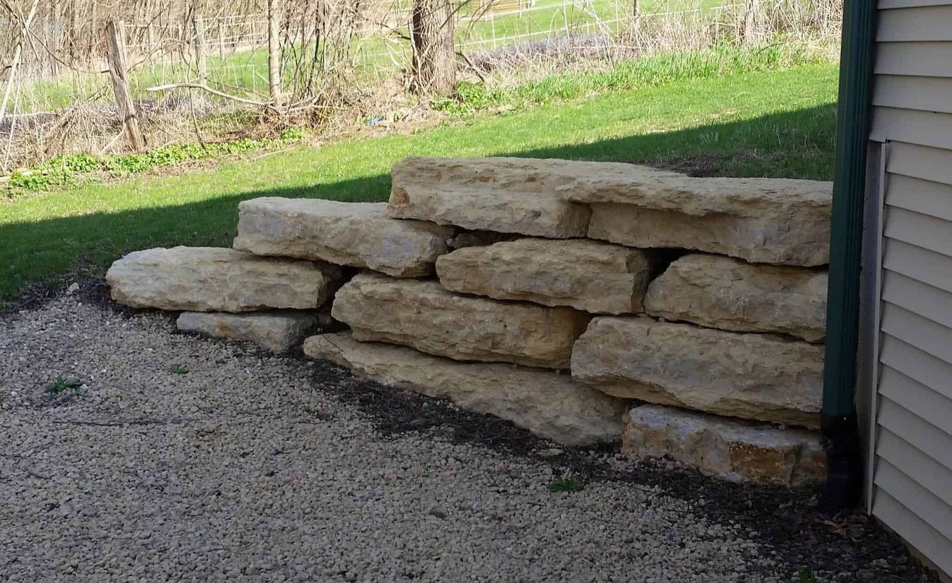 A pile of rocks is sitting next to a house.