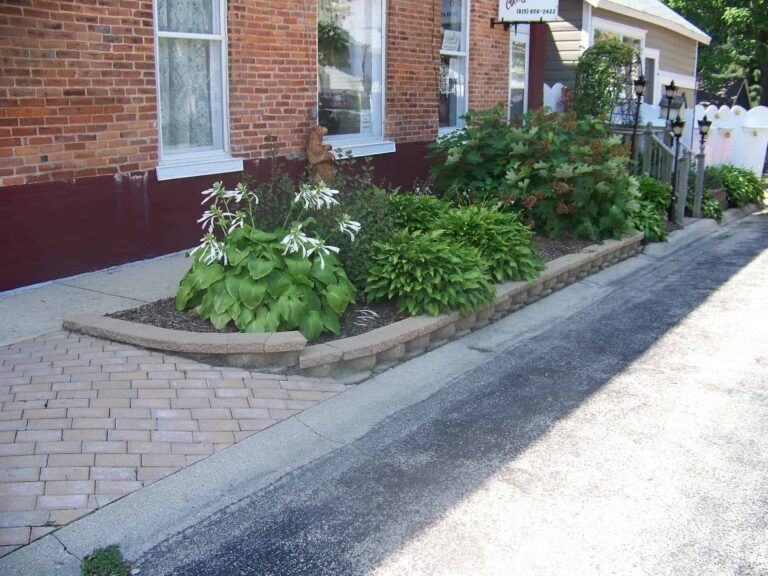 A brick house with a garden in front of it