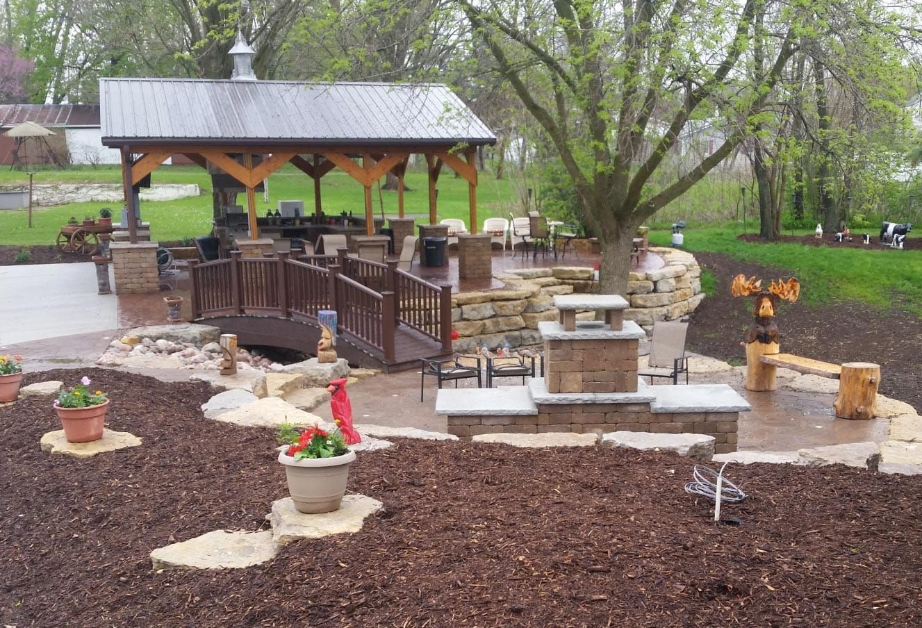 A patio area with a gazebo and a bridge