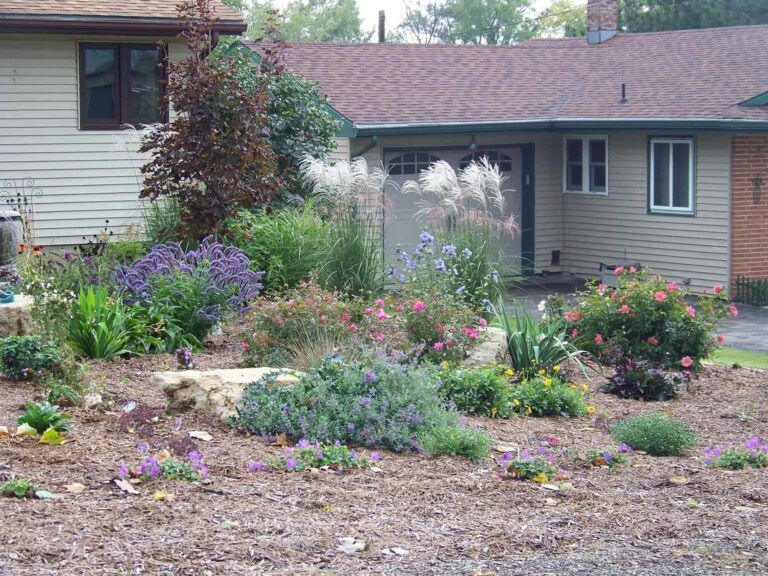 A house with a lot of flowers in front of it