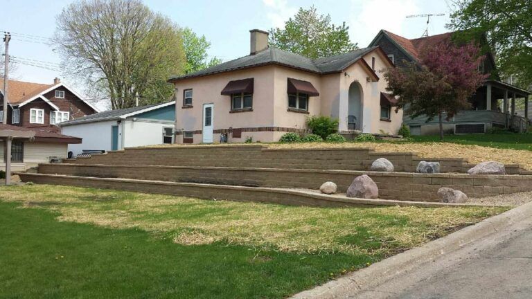A house with a lot of rocks in front of it
