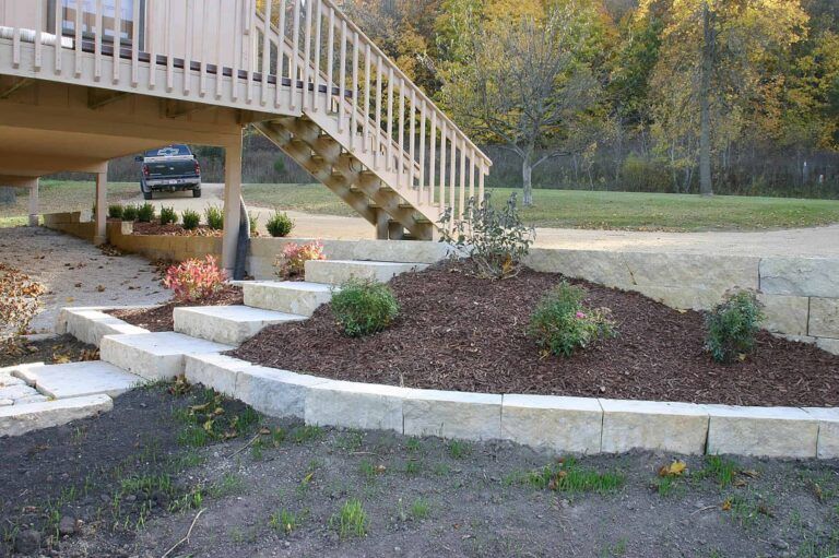 A house with a deck and stairs leading up to it.