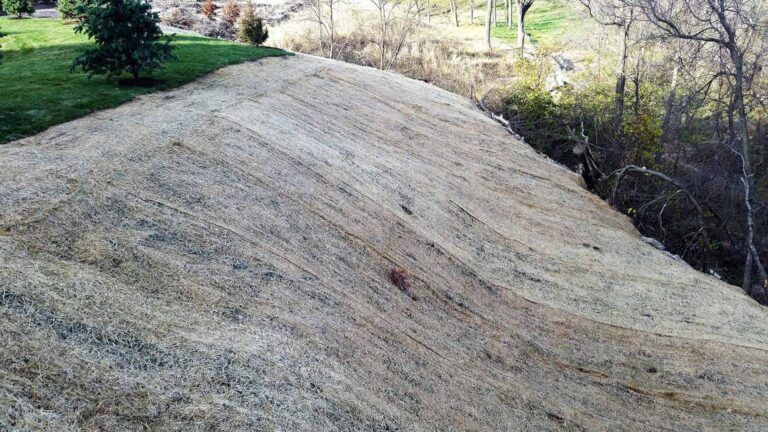 A large pile of dirt is sitting on top of a hill.