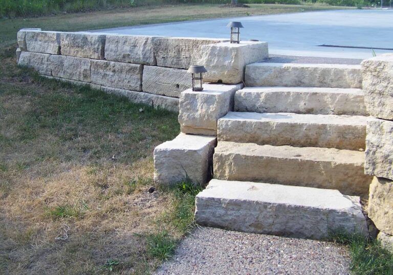 A set of stone stairs leading up to a lake