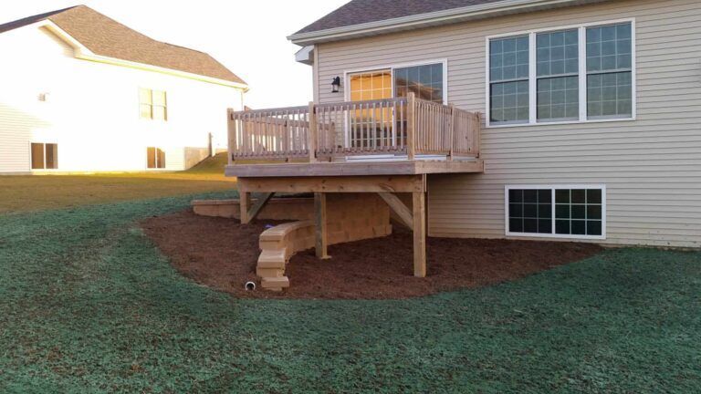 A house with a wooden deck in the backyard
