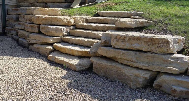 A pile of rocks stacked on top of each other on a gravel road.