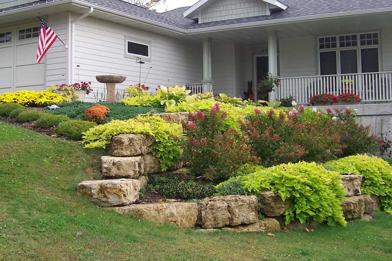A house with a lot of flowers in front of it