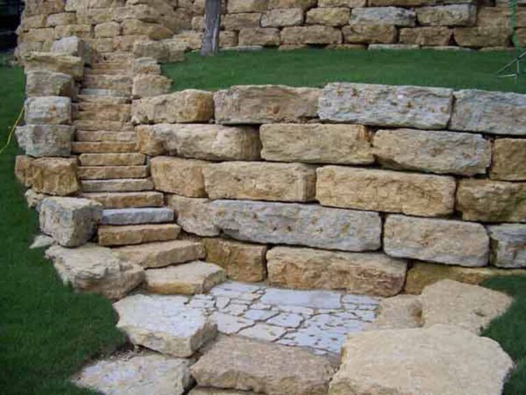 A stone wall with stairs leading up to it.