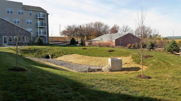 A large grassy field with a building in the background.