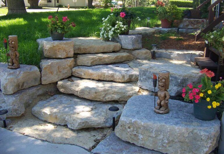 A stone staircase with flowers and statues on the steps