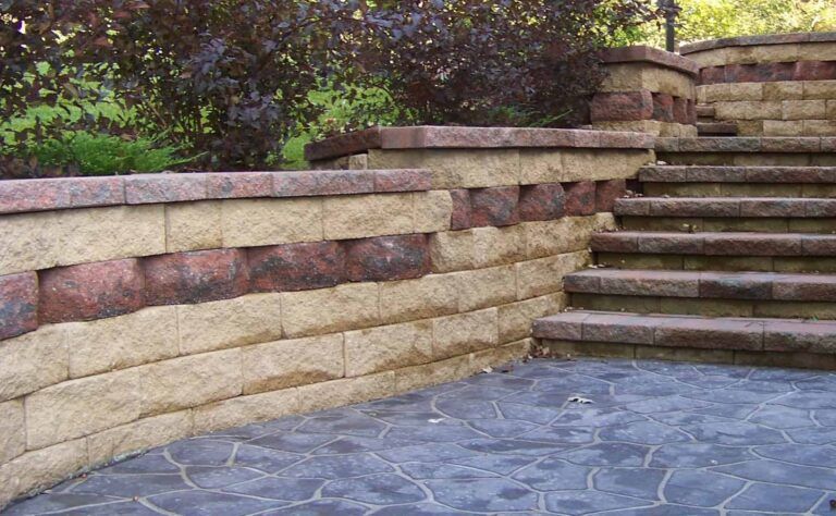A stone wall with stairs leading up to it.