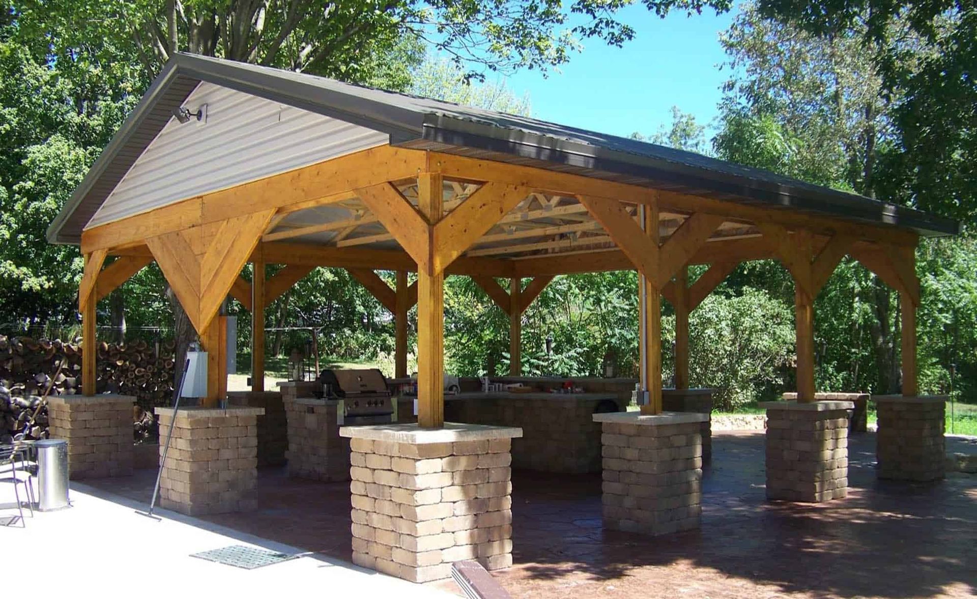 A pavilion with a wooden roof and brick pillars