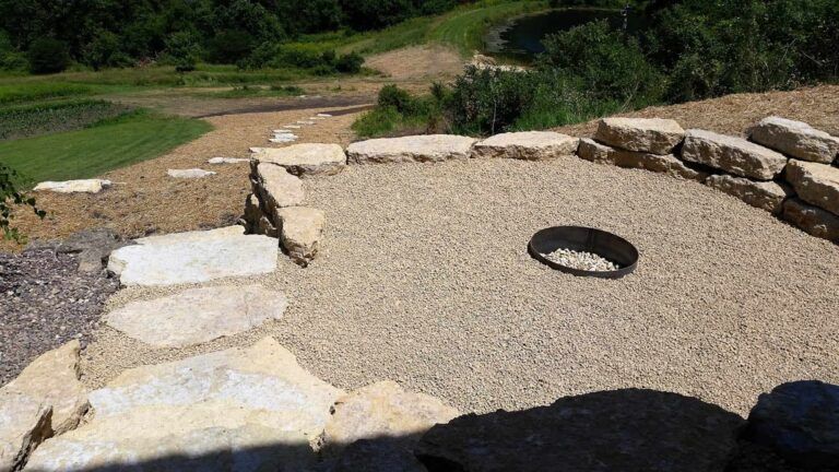 There is a fire pit in the middle of a rocky area.