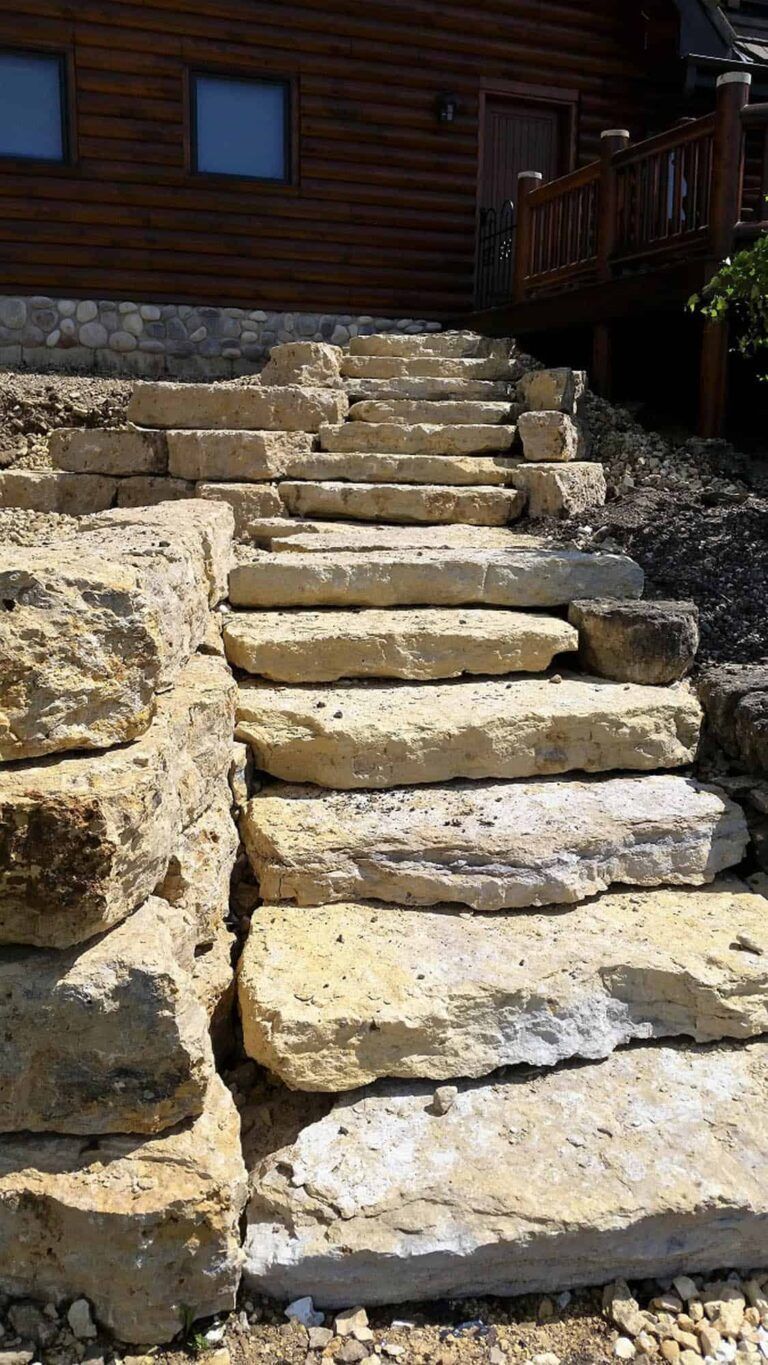 A set of stone stairs leading up to a wooden house.