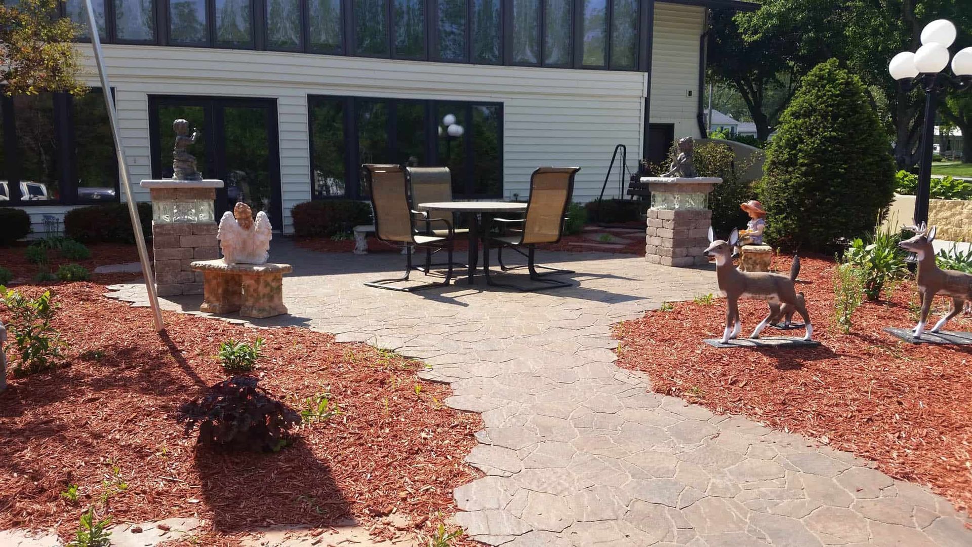 A patio with a table and chairs in front of a house