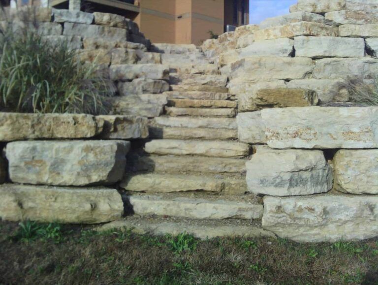 A stone wall with stairs leading up to it