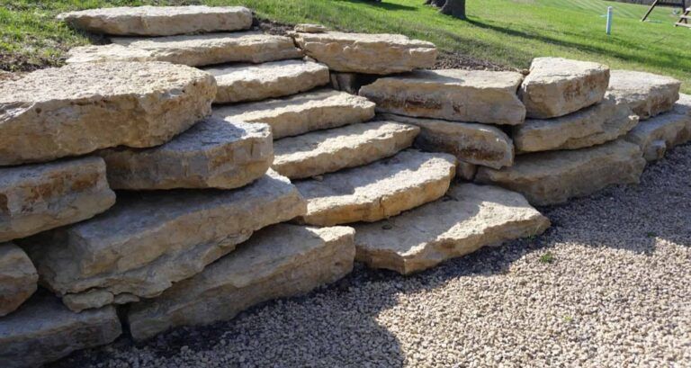 A pile of rocks stacked on top of each other on a gravel road.