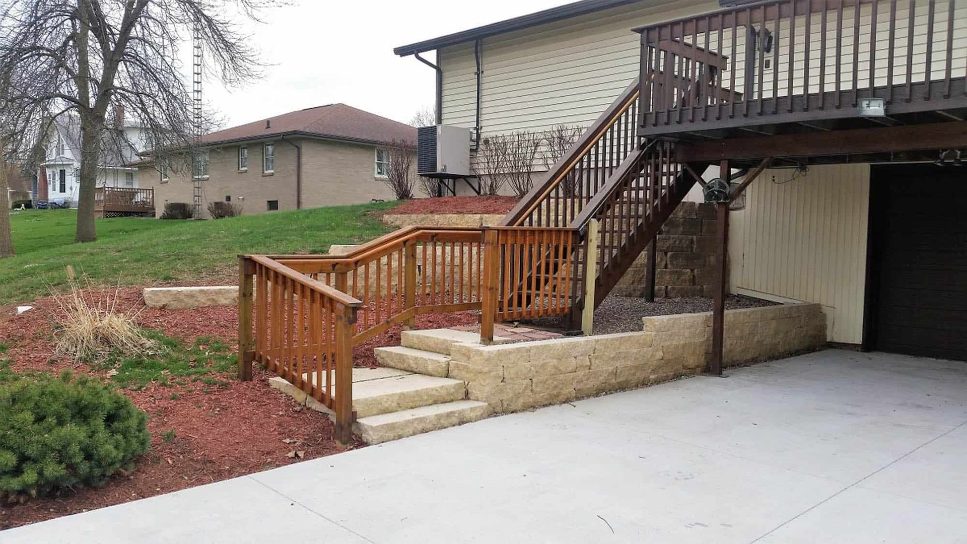 A house with a deck and stairs leading up to it.
