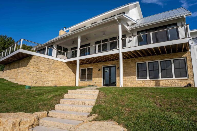 A large house on a hill with stairs leading up to it.