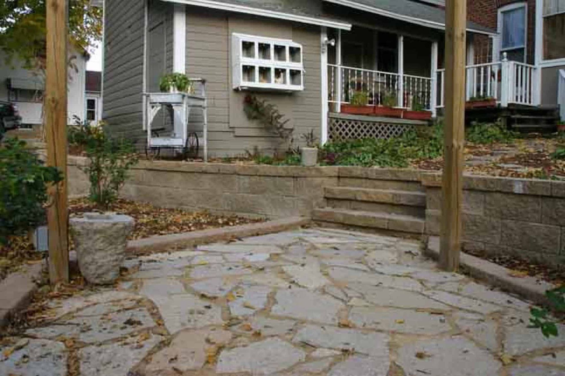 There is a stone patio in front of a house.