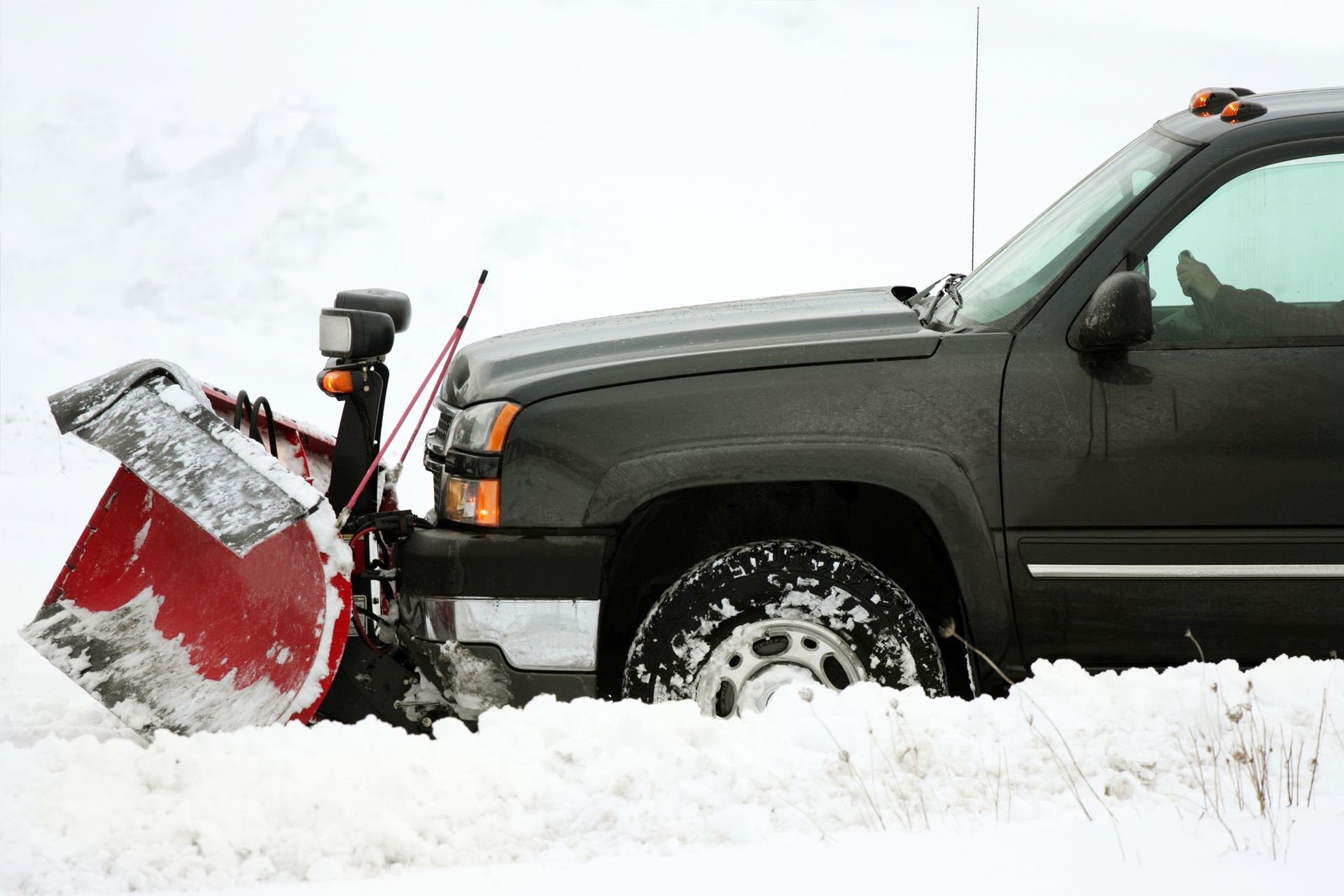 pickup truck with snow plow attached to front